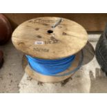 A WOODEN REEL WITH A BLUE BT DRAWROPE