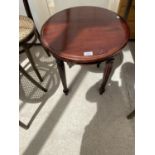 A MAHOGANY CIRCULAR SIDE TABLE WITH CARVED DETAILING TO LEGS AND SIDES