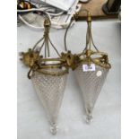 A PAIR OF VINTAGE CEILING LAMPS WITH ORNATE GILT TOPS AND GLASS SHADES