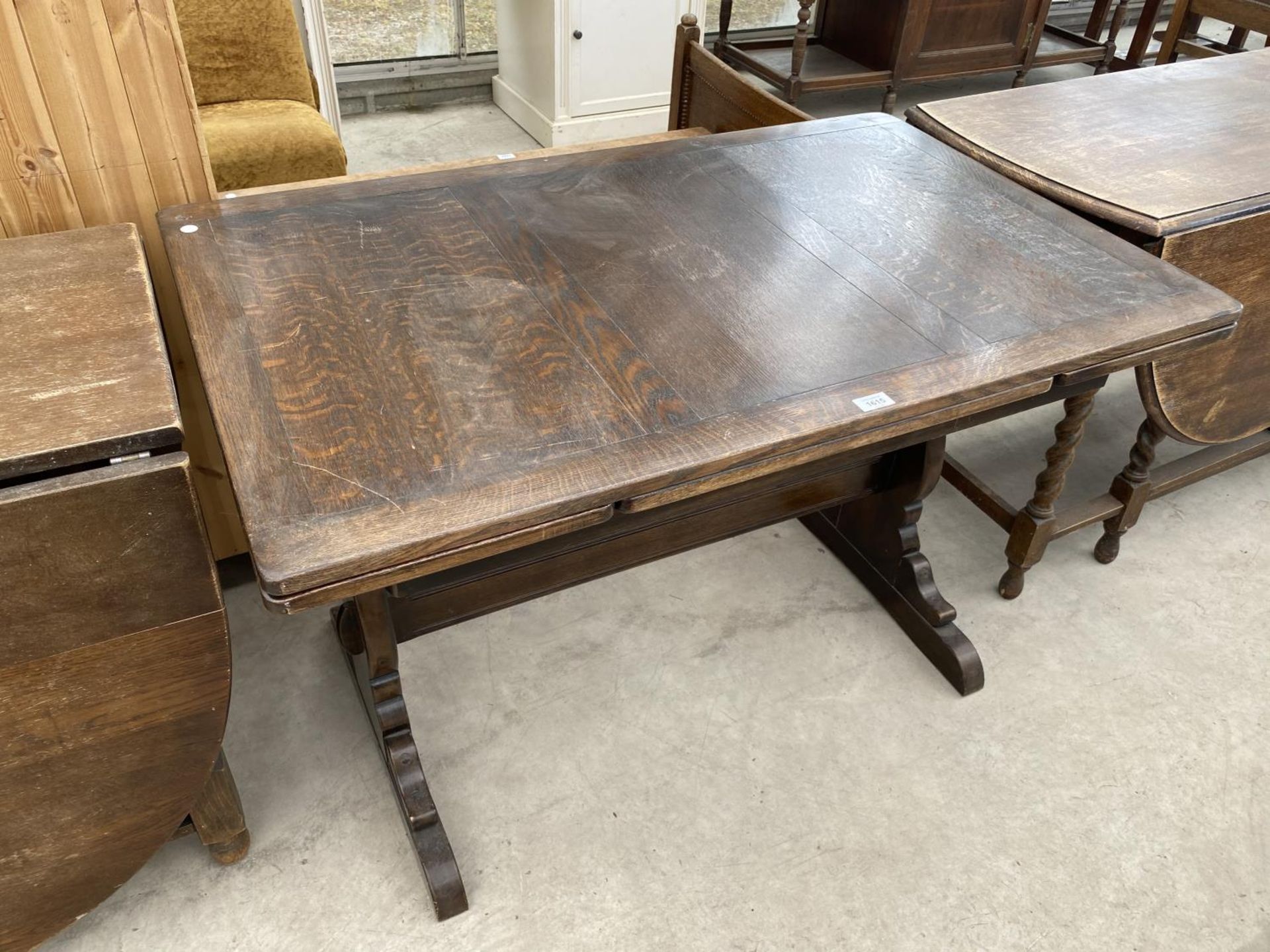 AN OAK DRAW LEAF DINING TABLE