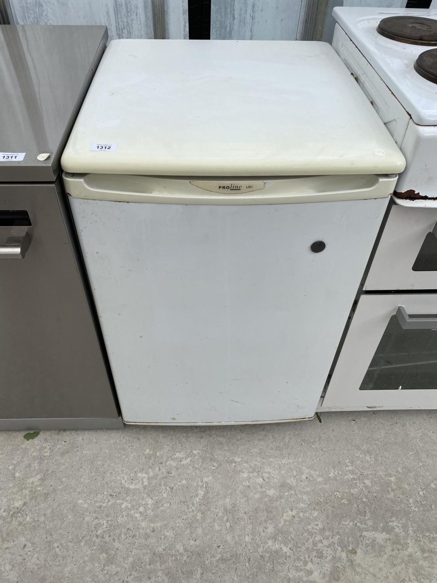 A PROLINE FRIDGE IN NEED OF CLEAN IN WORKING ORDER