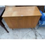 A TEAK SEWING MACHINE CABINET