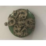 A GREEN STONE PENDANT WITH WHITE METAL DRAGON DECORATION (POSSIBLY JADE)