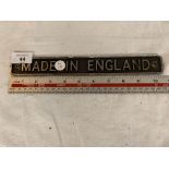 A CAST 'MADE ON ENGLAND' SIGN 10.5 INCHES LONG