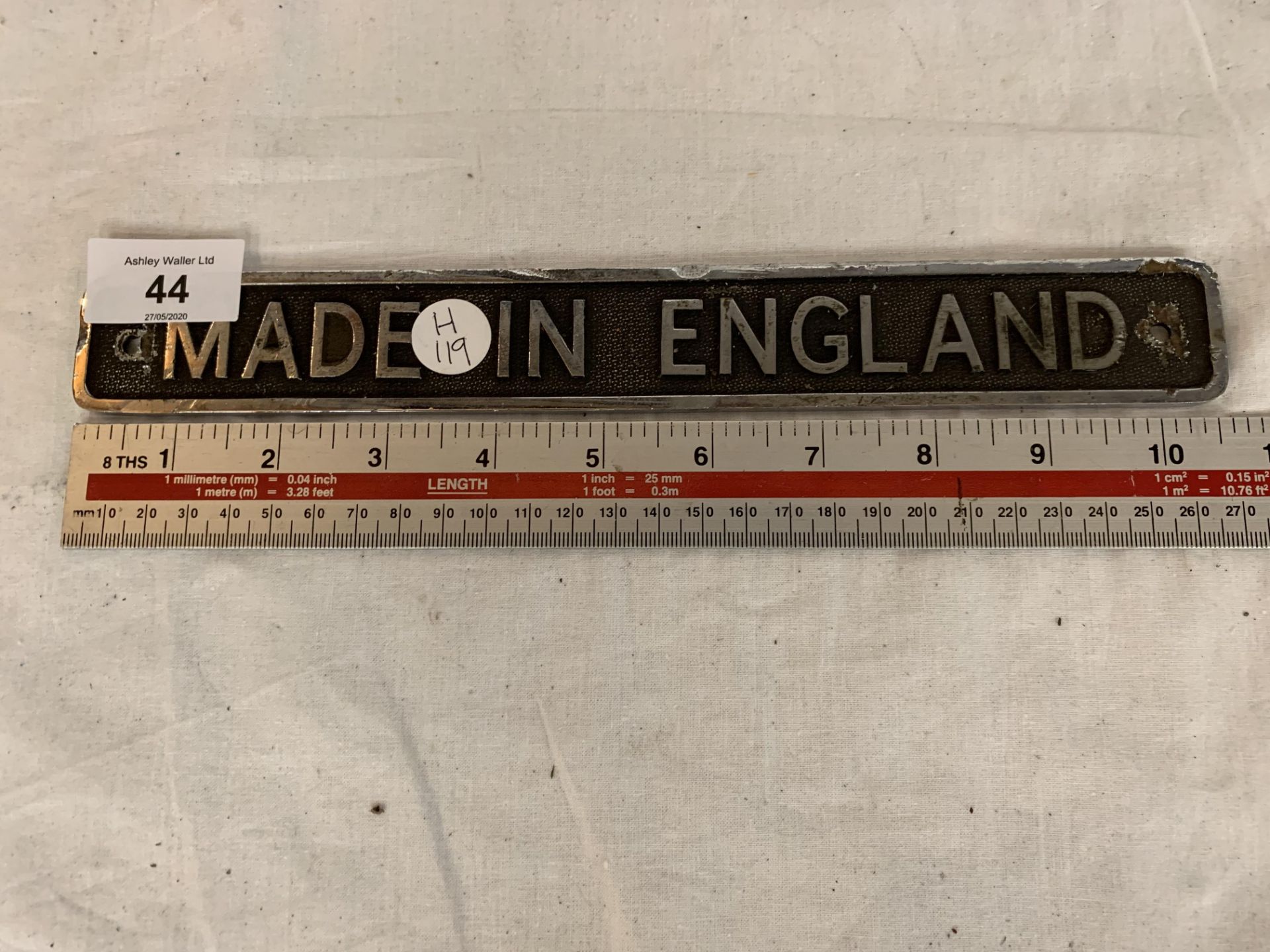 A CAST 'MADE ON ENGLAND' SIGN 10.5 INCHES LONG