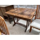 AN OAK DRAW LEAF DINING TABLE