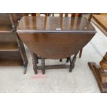 AN OVAL OAK DROP LEAF SIDE TABLE ON BOBBIN TURNED SUPPORTS