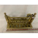 A BRASS GATE STYLE PIPE RACK