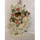 A STAFFORDSHIRE CERAMIC FIGURE OF A LADY AND GENT WITH SPANIEL POCKET WATCH STAND