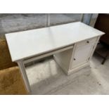 A WHITE PAINTED DESK WITH ONE DOOR AND ONE DRAWER