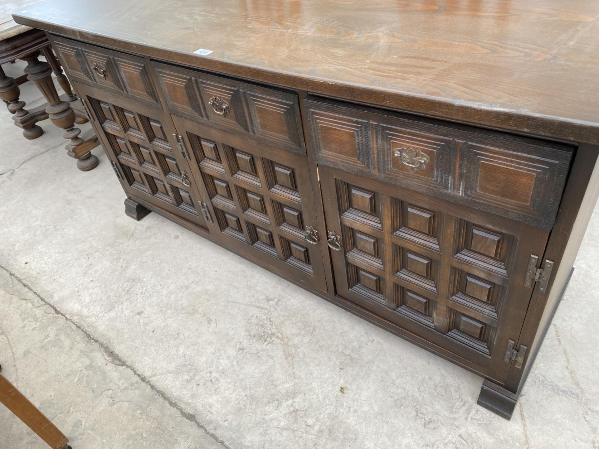 A YOUNGER TOLEDO OAK SIDEBOARD WITH THREE DOORS AND THREE DRAWERS - Image 3 of 3