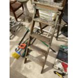 A SET OF VINTAGE STEP LADDERS AND GARDEN TOOLS - SAW, LOPPERS ETC