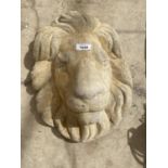 A CONCRETE LION HEAD PLAQUE