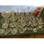 A LARGE COLLECTION OF VARIOUS GLASS AND CUT GLASS ITAMS TO INCLUDE DECANTERS, JUGS, DISHES,