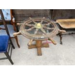 A SHIP'S WHEEL COFFEE TABLE WITH GLASS TOP