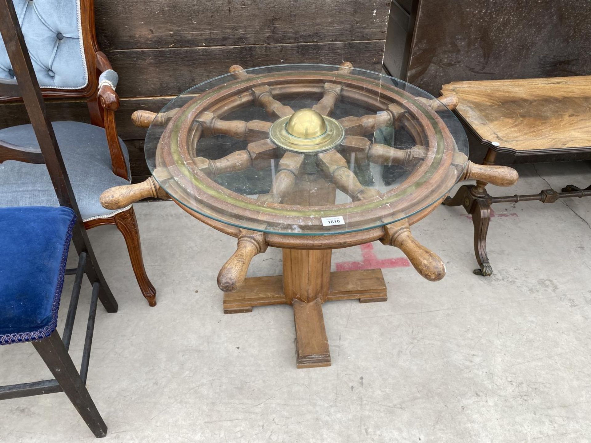 A SHIP'S WHEEL COFFEE TABLE WITH GLASS TOP