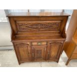 A LATE VICTORIAN CARVED AMERICAN WALNUT BUREAU WITH FALL FRONT REVEALING LEATHER WRITING SURFACE,
