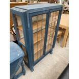 A BLUE CHINA CABINET WITH TWO DOORS