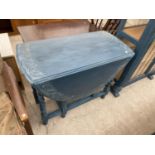 A BLUE DROP LEAF TABLE WITH CARVED TOP