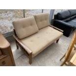 A RETRO WHITELEAF TEAK EXTENDING TWO SEATER SOFA