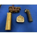 A BRASS SHELL CASE, OIL CAN, BULLET POUCH AND TORCH