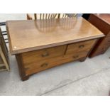 A LOW OAK CHEST OF TWO SHORT AND ONE LONG DRAWER