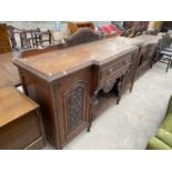 A CARVED MAHOGANY SIDEBOARD WITH TWO DOORS AND TWO DRAWERS