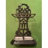 A CAST METAL STICK/UMBRELLA STAND WITH BOTH TRAYS