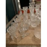 A LARGE COLLECTION OF CUT GLASS ITEMS TO INCLUDE BASKETS, VASES, BOWLS, CANDLESTICKS ETC