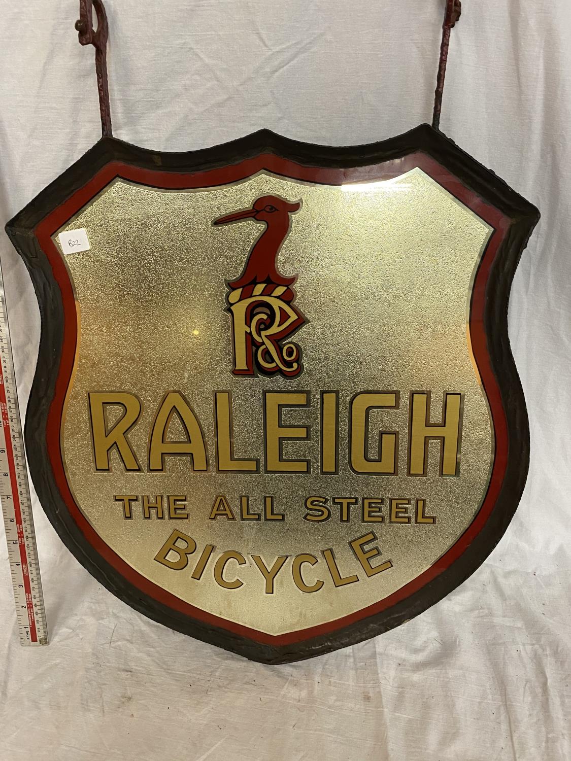 A VINTAGE GLASS AND MIRRORED "RALEIGH, THE ALL STEEL BICYCLE" DOUBLE SIDED ADVERTISING SIGN IN RED