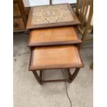 A RETRO (BELIEVED G PLAN) TEAK NEST OF TABLE, THE LARGEST HAVING TILED TOP