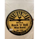 A CIRCULAR 'SUN RECORD COMPANY WHERE ROCK AND ROLL WAS BORN!' METAL SIGN