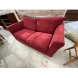 A RED TWO SEATER SOFA