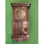 A 1920'S GERMAN OAK CASED CHIMING WALL CLOCK