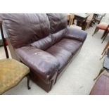 A RED LEATHER TWO SEATER SOFA
