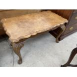 A WALNUT COFFEE TABLE ON CARVED CABRIOLE SUPPORTS