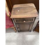 A PRIORY STYLE OAK BEDSIDE CABINET WITH ONE DOOR AND ONE DRAWER