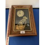 A FRAMED CLOCK WITH A GOLF BAG AND CLUBS DECORATION