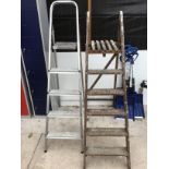 A VINTAGE SIX RUNG WOODEN STEP LADDER AND A ALUNIMIUM FOUR RUNG