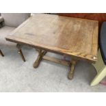 AN OAK DRAW LEAF TABLE ON PINEAPPLE BALUSTER SUPPORTS