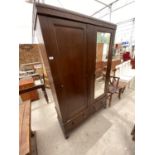 AN OAK WARDROBE WITH BEVEL EDGE DOOR, FURTHER DOOR AND TWO LOWER DRAWERS