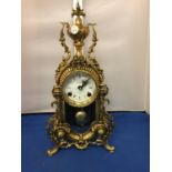 A BRASS CARVED MANTLE CLOCK