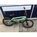 A MONGOOSE BMX BIKE WITH FRONT AND REAR STUNT PEGS