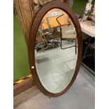 EARLY 20TH CENTURY OVAL MAHOGANY FRAMED WALL MIRROR WITH BEVELLED GLASS, 55 X 98 CM