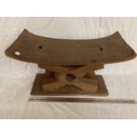 AN AFRICAN ASHANTI STOOL WITH CURVED SEAT