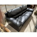 A BLACK LEATHER TWO SEATER SOFA