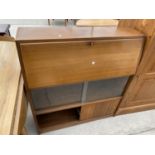 A RETRO TEAK BUREAU WITH FALL FRONT AND FOUR SLIDING GLASS DOORS