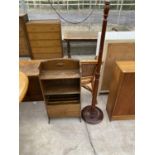 AN OAK MAGAZINE RACK AND A MAHOGANY STANDARD LAMP