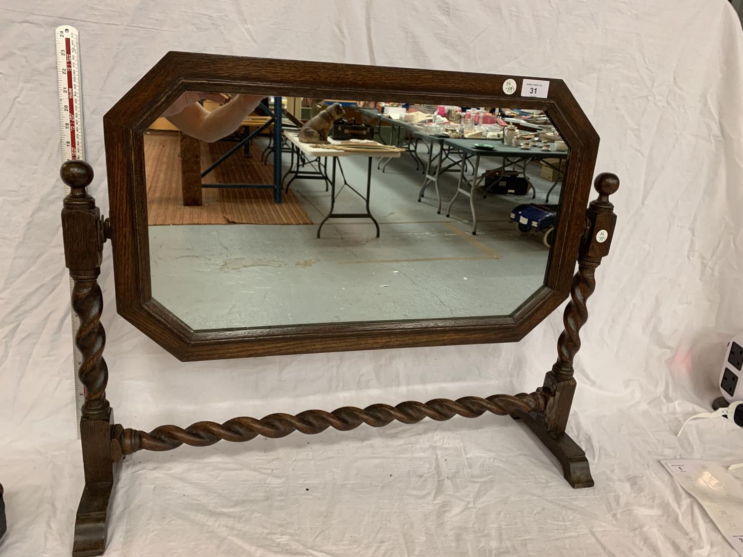 AN OAK FRAMED MIRROR ON A BARLEY TWIST FRAME