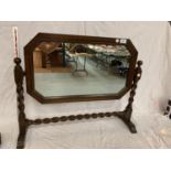 AN OAK FRAMED MIRROR ON A BARLEY TWIST FRAME